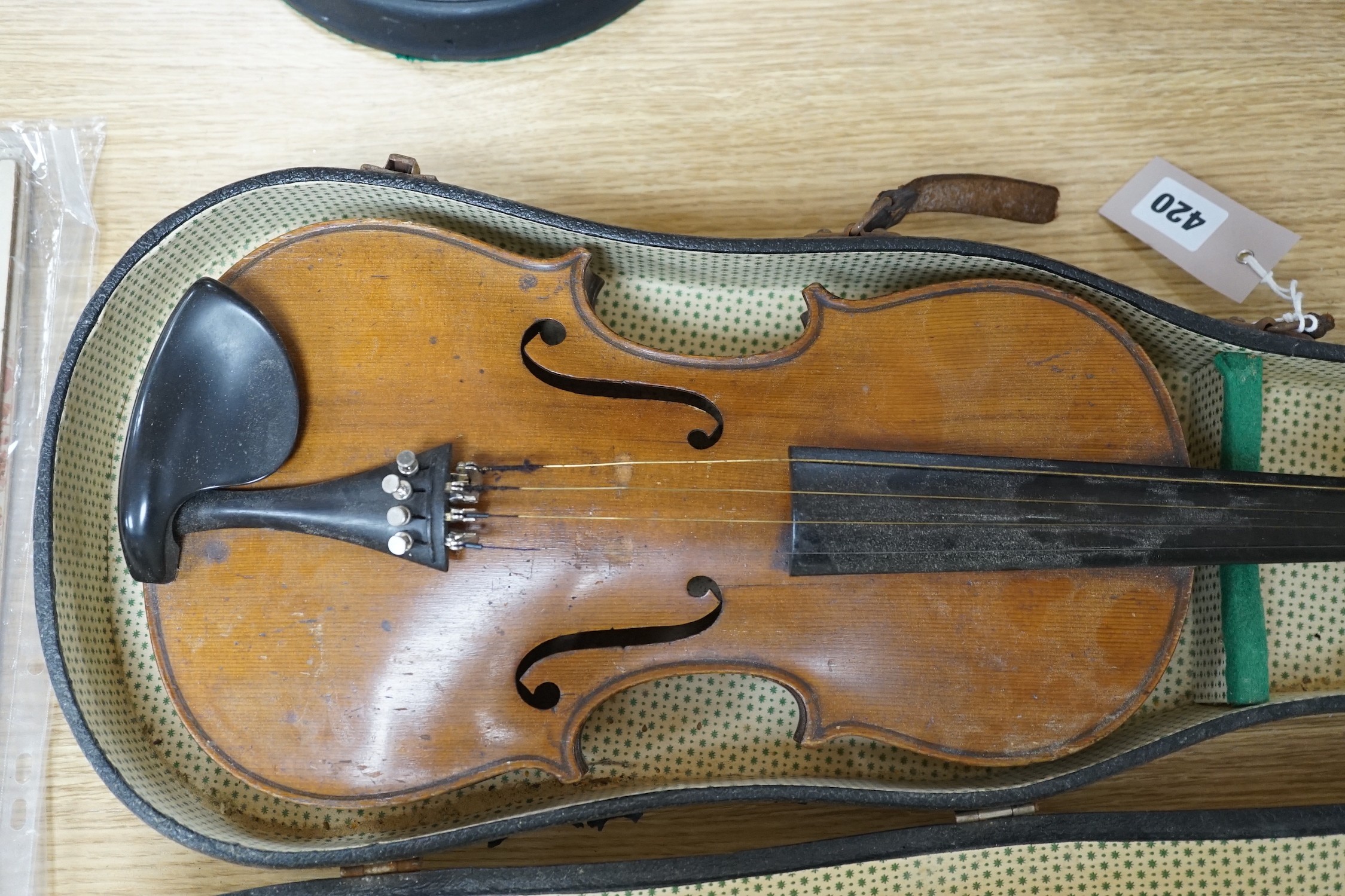 A cased violin, interior label reads ‘copy of Antonius Straduarius made in Germany’, back measures 35.5cm